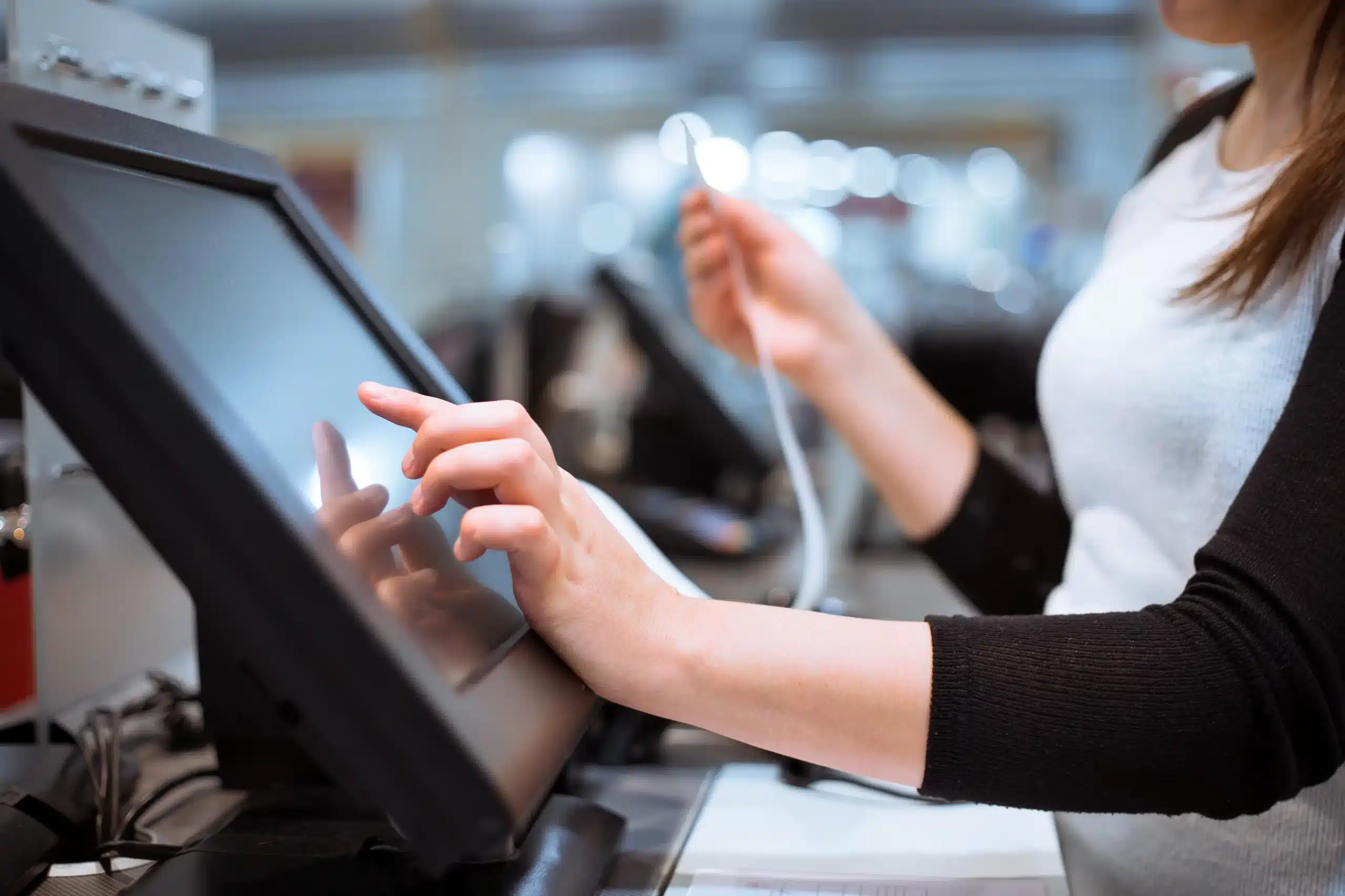 young woman hands scaning entering discount sale receipt touchscreen cash register market shop 1 scaled